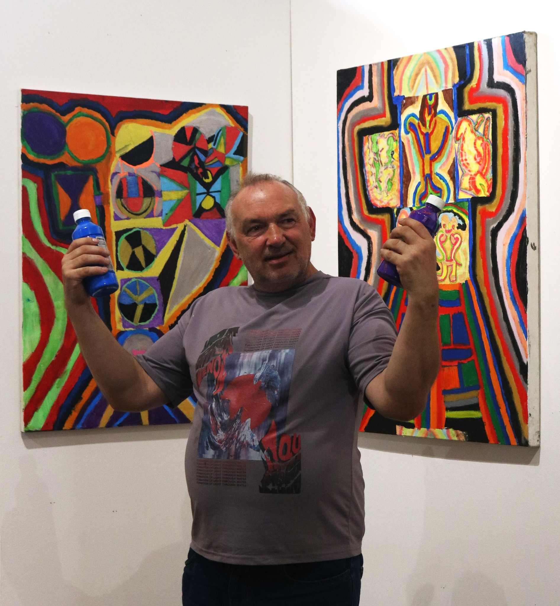 Patrick standing in front of some of his hung work